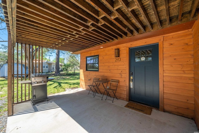 view of patio featuring a shed, an outdoor structure, and area for grilling