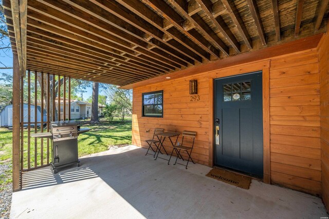 view of patio featuring a shed, an outdoor structure, and area for grilling