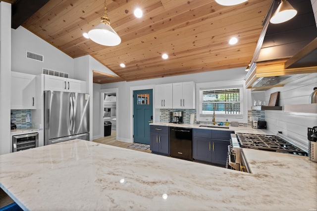 kitchen featuring hanging light fixtures, open shelves, appliances with stainless steel finishes, and white cabinets