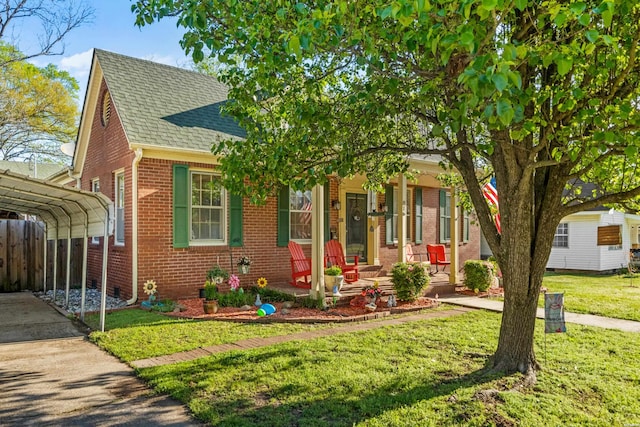 view of front of home featuring a porch, a front yard, fence, brick siding, and a shingled roof