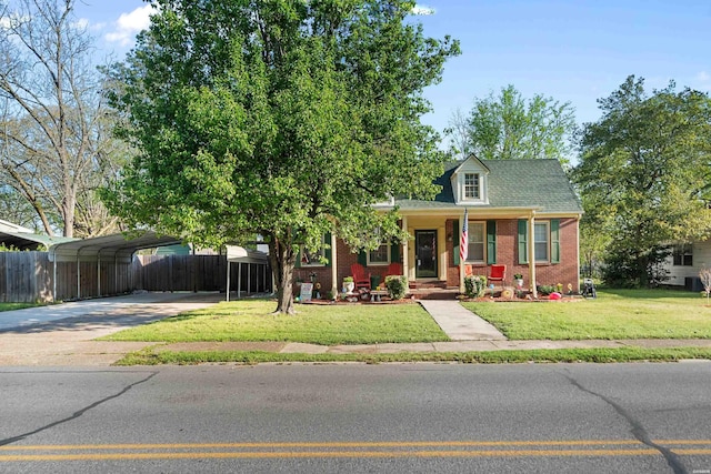 bungalow-style house featuring a carport, a front yard, fence, brick siding, and driveway