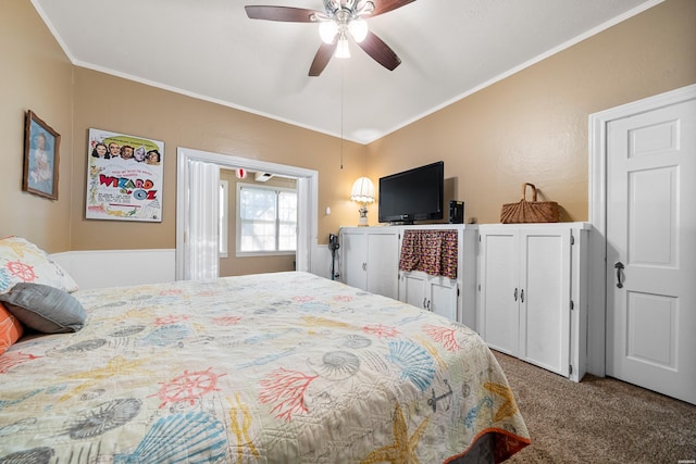 bedroom with ceiling fan, ornamental molding, and carpet