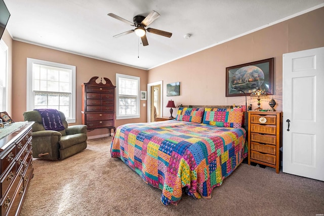carpeted bedroom with ceiling fan and ornamental molding