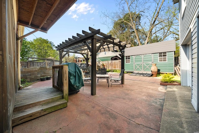 view of patio / terrace featuring a pergola, a fenced backyard, a shed, and an outdoor structure