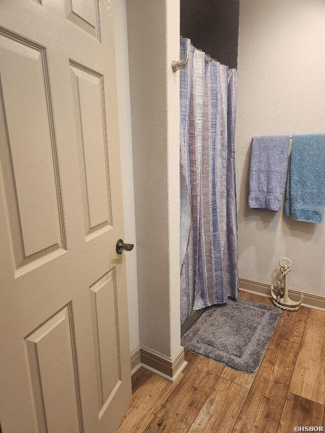 bathroom featuring baseboards and wood finished floors