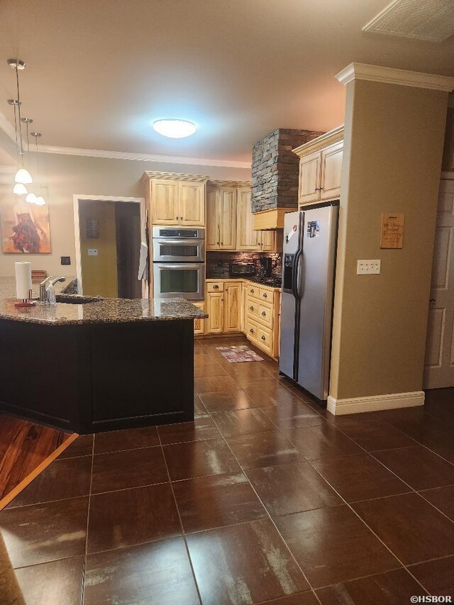 kitchen with crown molding, appliances with stainless steel finishes, pendant lighting, and a sink