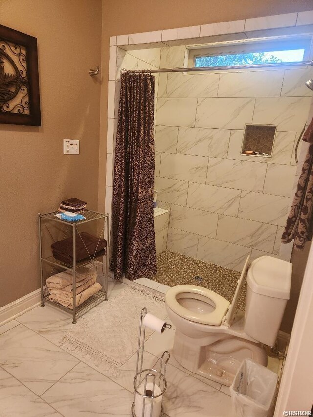 full bathroom with a stall shower, plenty of natural light, baseboards, toilet, and marble finish floor