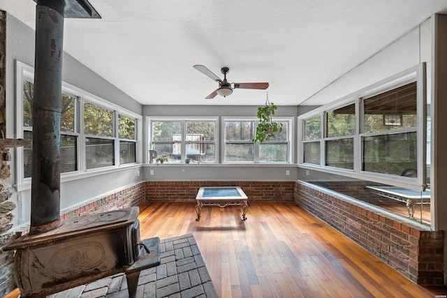 unfurnished sunroom with a ceiling fan