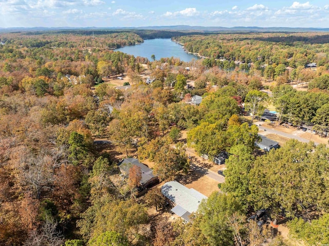 aerial view with a wooded view and a water view