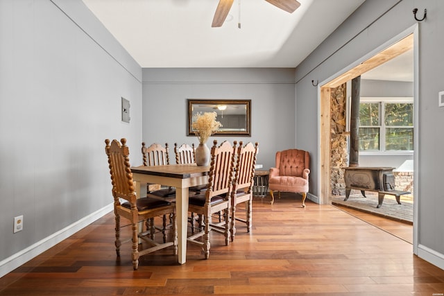 dining area featuring baseboards, a ceiling fan, and hardwood / wood-style floors