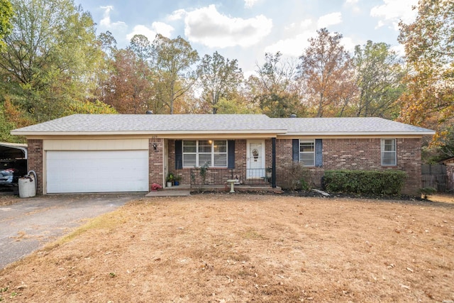 ranch-style home featuring aphalt driveway, a garage, and brick siding