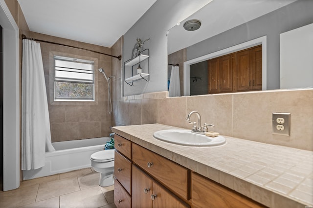 bathroom with vanity, tile patterned flooring, tile walls, toilet, and shower / tub combo with curtain