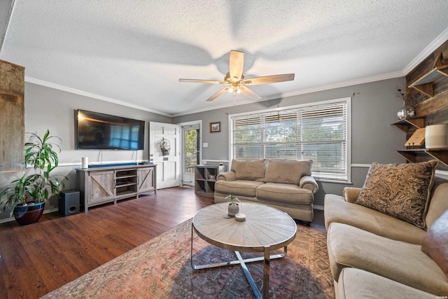 living room featuring ornamental molding, a textured ceiling, a ceiling fan, and wood finished floors