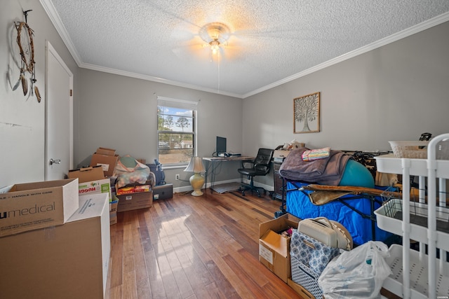 home office with ornamental molding, a textured ceiling, baseboards, and wood-type flooring