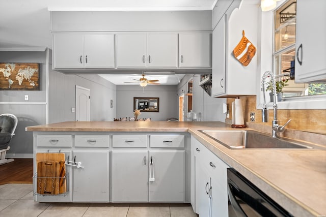 kitchen featuring a sink, white cabinets, light countertops, light tile patterned floors, and dishwasher