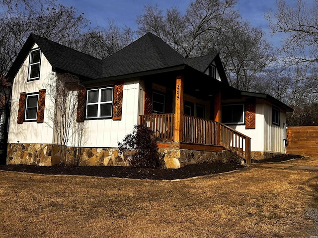 view of home's exterior with covered porch and roof with shingles