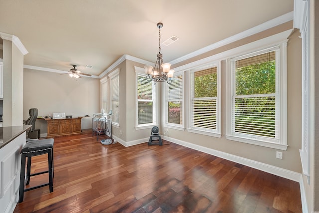 dining room with baseboards, crown molding, visible vents, and wood finished floors