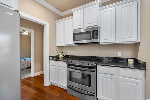 kitchen featuring baseboards, crown molding, dark wood-type flooring, stainless steel appliances, and white cabinets