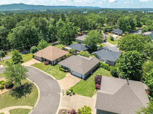 birds eye view of property with a forest view and a residential view