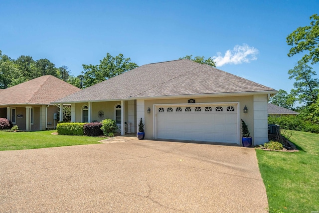 ranch-style house with roof with shingles, a garage, stucco siding, and driveway