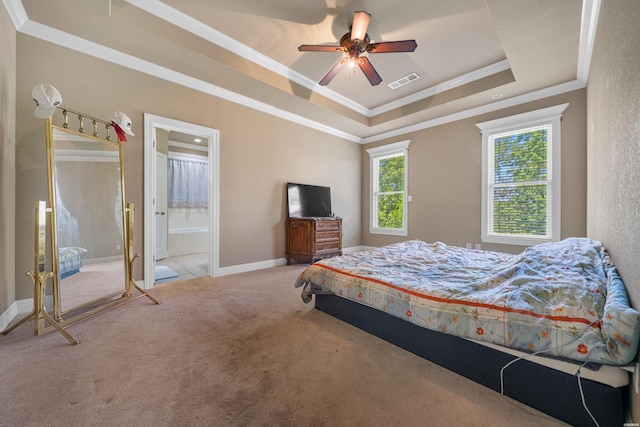 carpeted bedroom with baseboards, a raised ceiling, visible vents, and crown molding