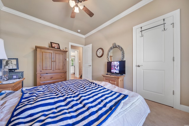 bedroom featuring ornamental molding, ceiling fan, and light colored carpet