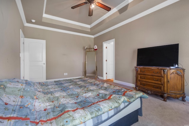 bedroom with crown molding, ceiling fan, carpet flooring, a tray ceiling, and baseboards