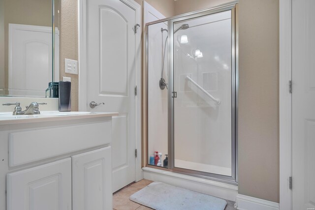 bathroom featuring a stall shower, tile patterned flooring, and vanity