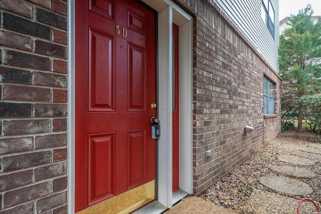 entrance to property with brick siding