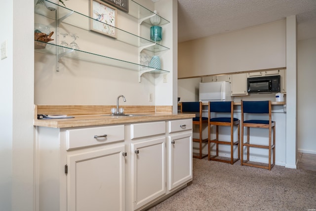 5371 Central Ave Unit 5D, Hot Springs, AR 71913 - bar with black microwave, a textured ceiling, a sink, and freestanding refrigerator