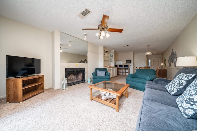 5371 Central Ave Unit 5D, Hot Springs, AR 71913 - carpeted living area featuring a textured ceiling, ceiling fan, a fireplace, and visible vents