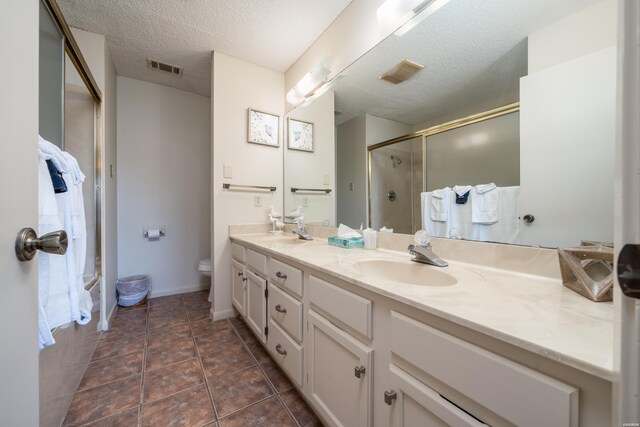 5371 Central Ave Unit 5D, Hot Springs, AR 71913 - bathroom with double vanity, visible vents, a stall shower, a sink, and a textured ceiling