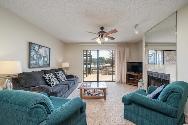 5371 Central Ave Unit 5D, Hot Springs, AR 71913 - living room featuring a ceiling fan, a textured ceiling, and a tiled fireplace