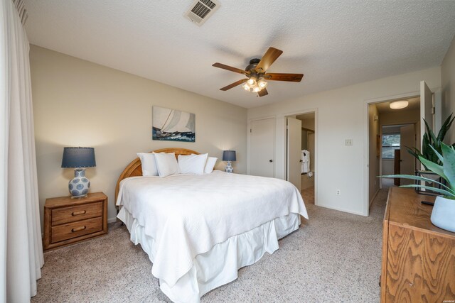 5371 Central Ave Unit 5D, Hot Springs, AR 71913 - bedroom with a textured ceiling, ceiling fan, connected bathroom, light carpet, and visible vents