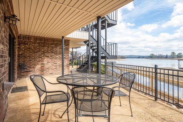 5371 Central Ave Unit 5D, Hot Springs, AR 71913 - view of patio featuring stairs, outdoor dining area, and a water view