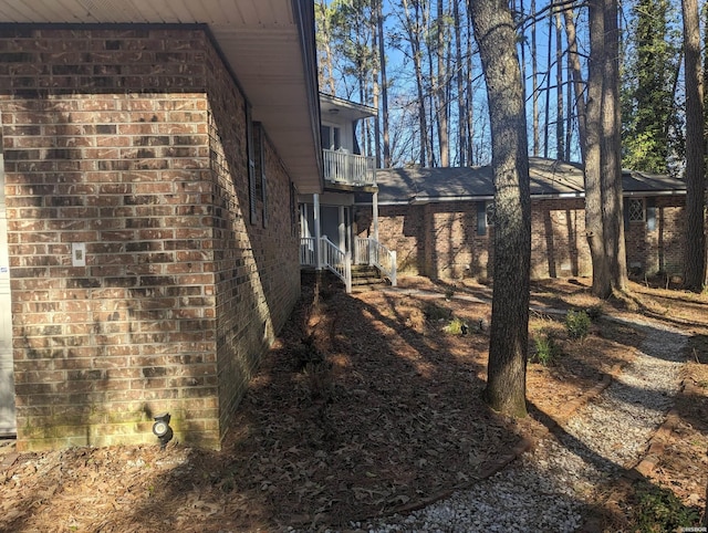 view of property exterior with brick siding