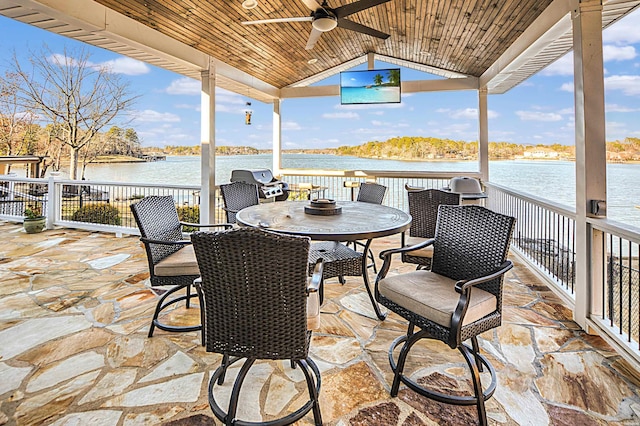 view of patio / terrace with outdoor dining space, a water view, and ceiling fan