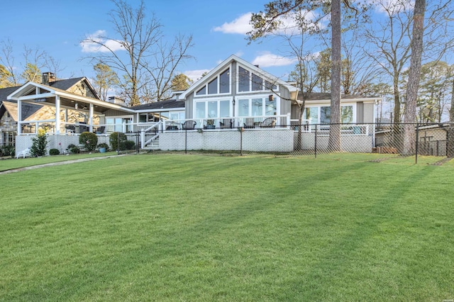 back of house featuring a yard and fence