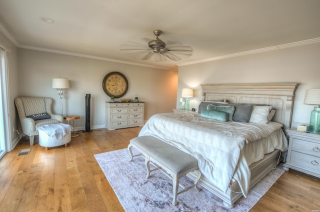 bedroom featuring ceiling fan, light wood-style flooring, visible vents, baseboards, and ornamental molding