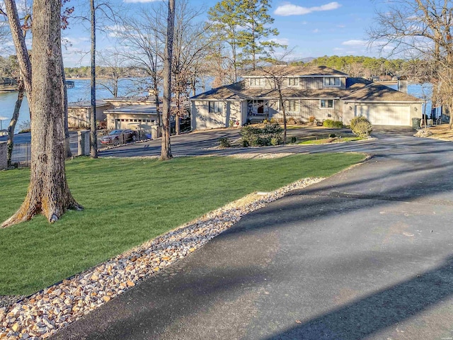 view of front of home with a water view and a front yard