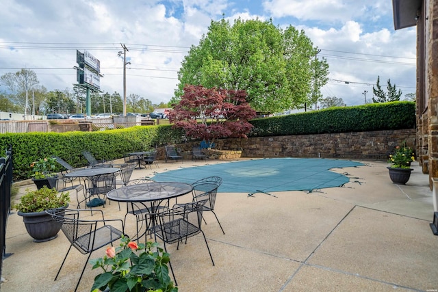 view of pool featuring fence and a patio