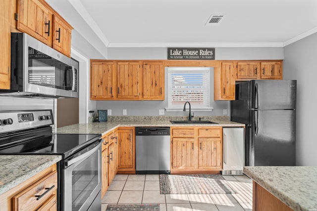 kitchen with light tile patterned floors, visible vents, appliances with stainless steel finishes, ornamental molding, and a sink