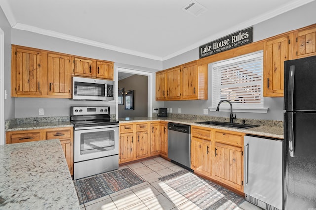 kitchen with crown molding, visible vents, appliances with stainless steel finishes, light tile patterned flooring, and a sink