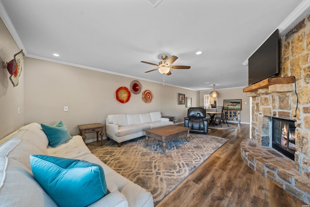 living area with recessed lighting, a fireplace, wood finished floors, a ceiling fan, and ornamental molding