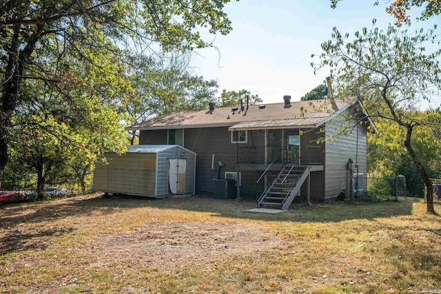 102 Brandiles Ln, Hot Springs, AR 71913 - rear view of property featuring an outdoor structure, fence, stairs, a lawn, and a shed