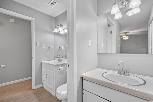 102 Brandiles Ln, Hot Springs, AR 71913 - full bathroom with two vanities, visible vents, a sink, a textured ceiling, and wood finished floors