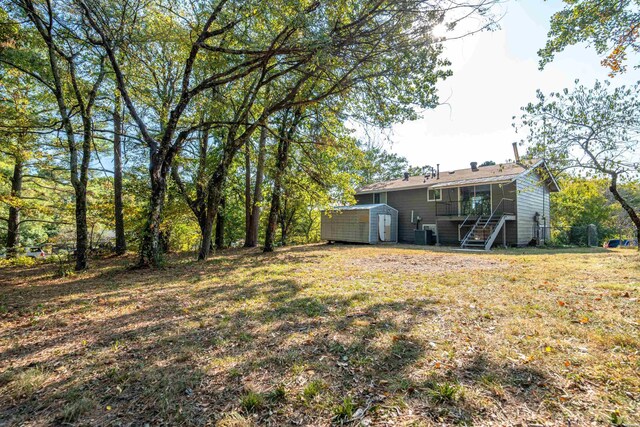 102 Brandiles Ln, Hot Springs, AR 71913 - view of yard featuring central air condition unit, an outdoor structure, stairway, and a shed