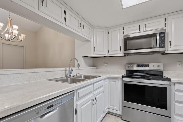 12 Beldoir Ct Unit 12, Hot Springs, AR 71901 - kitchen with stainless steel appliances, light countertops, white cabinets, a chandelier, and pendant lighting