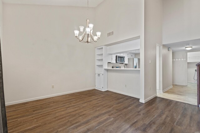 12 Beldoir Ct Unit 12, Hot Springs, AR 71901 - unfurnished living room with a high ceiling, a chandelier, and dark wood-style floors