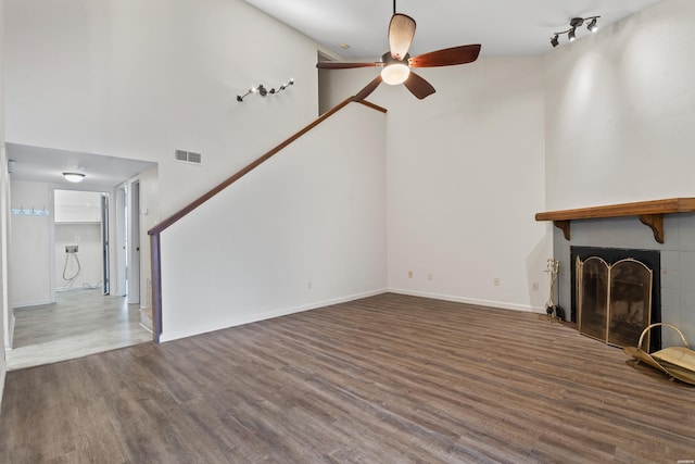 12 Beldoir Ct Unit 12, Hot Springs, AR 71901 - unfurnished living room with a towering ceiling, a ceiling fan, a fireplace, and wood finished floors